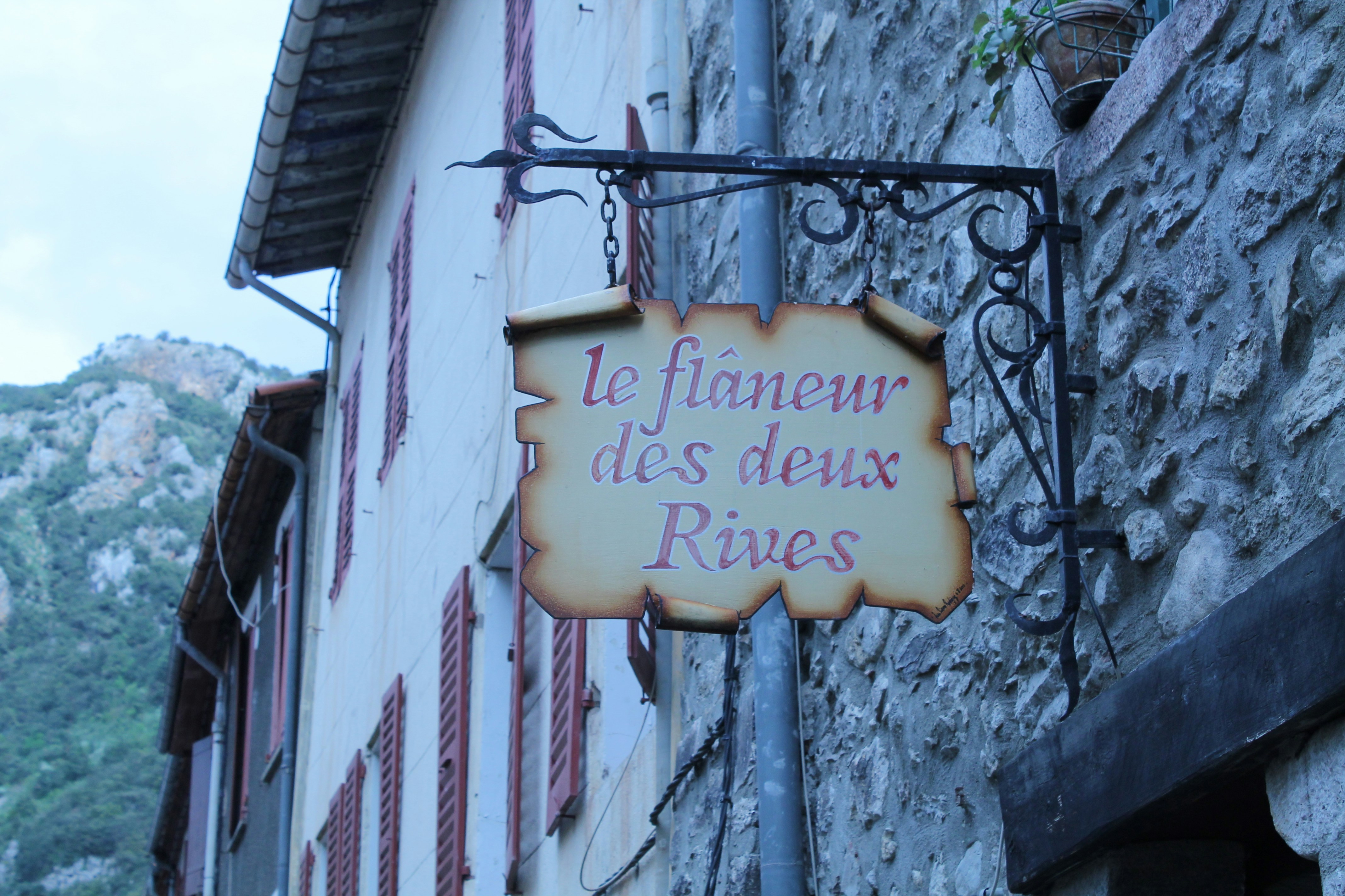 a sign hanging from the side of a building