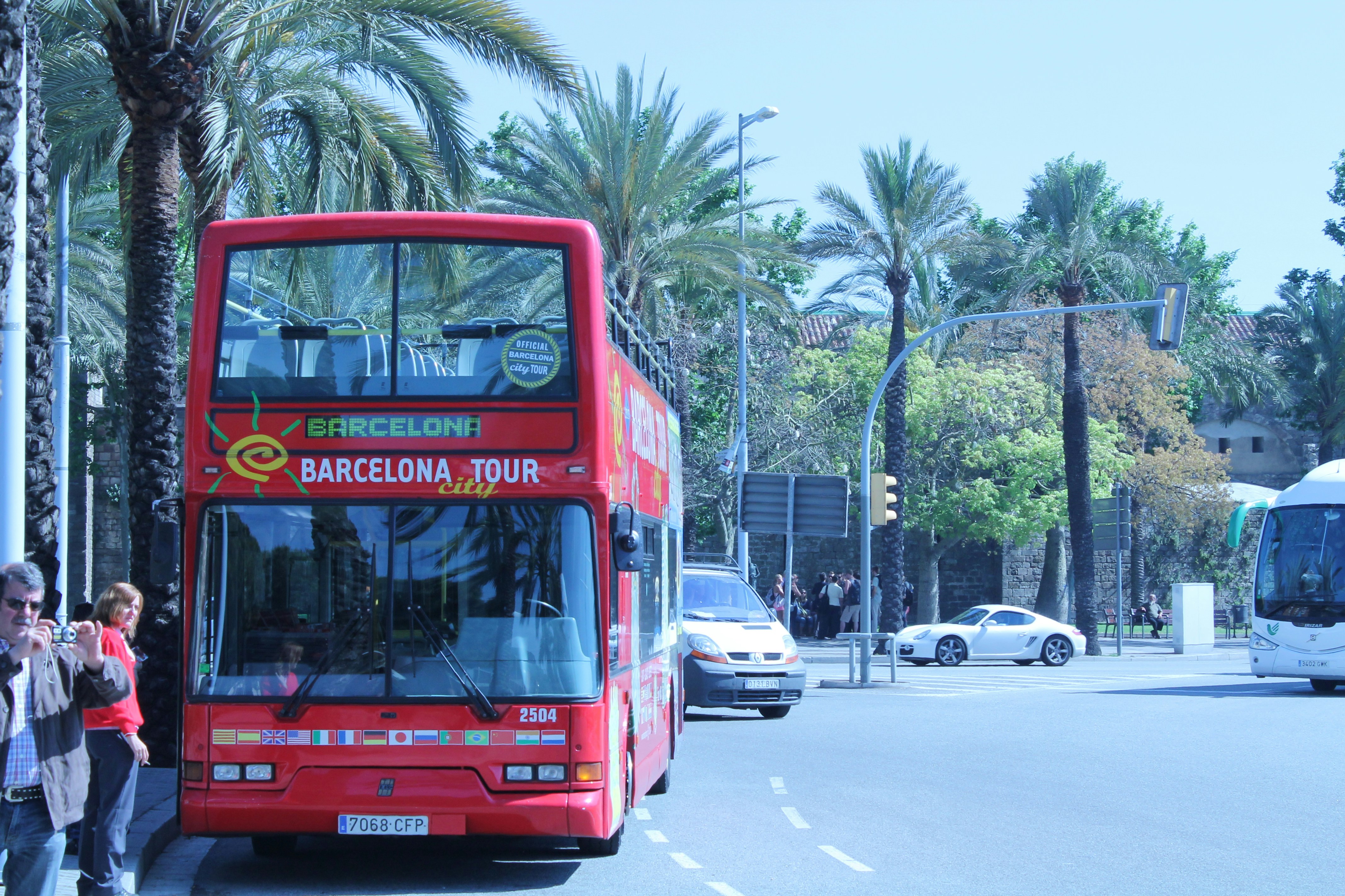 a red double decker bus driving down a street