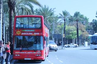 a red double decker bus driving down a street