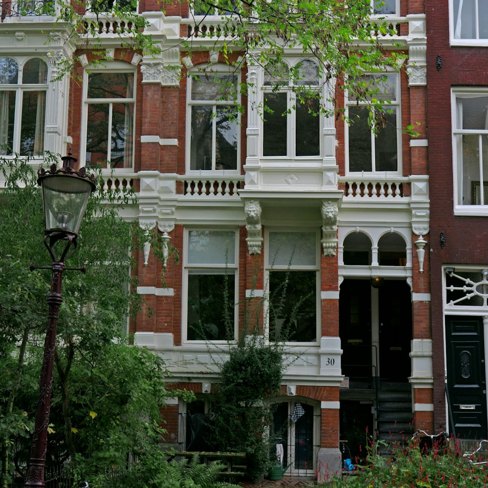 a street light sitting in front of a tall brick building