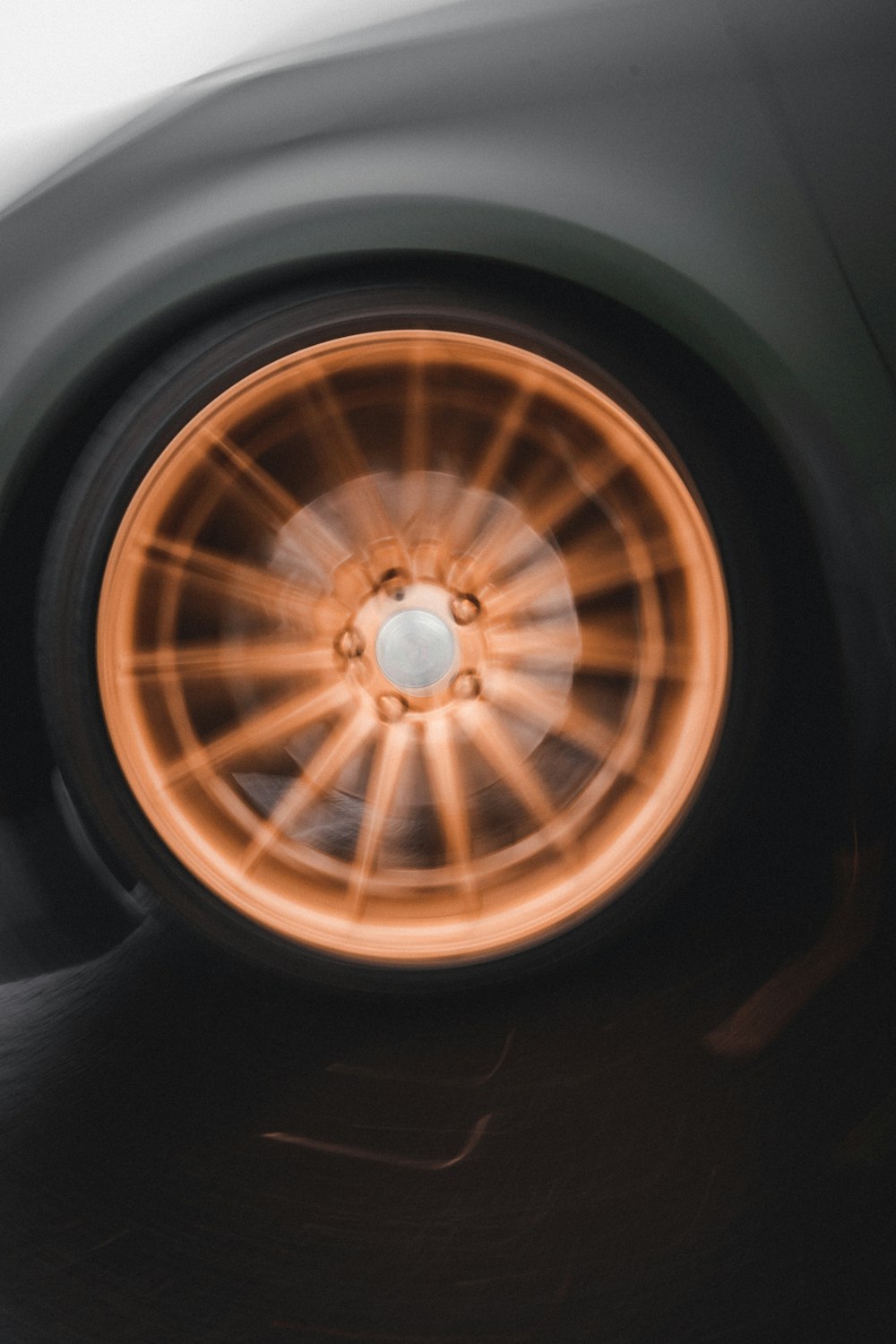 a close up of a car wheel with orange spokes
