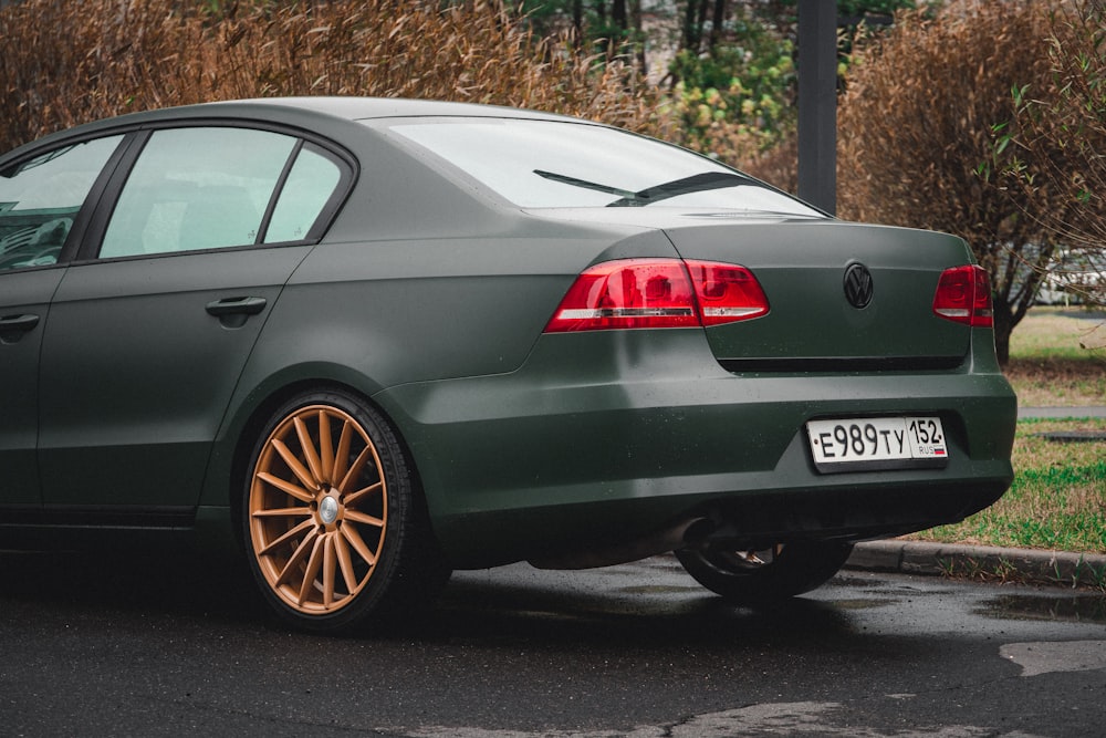 a green car parked on the side of the road