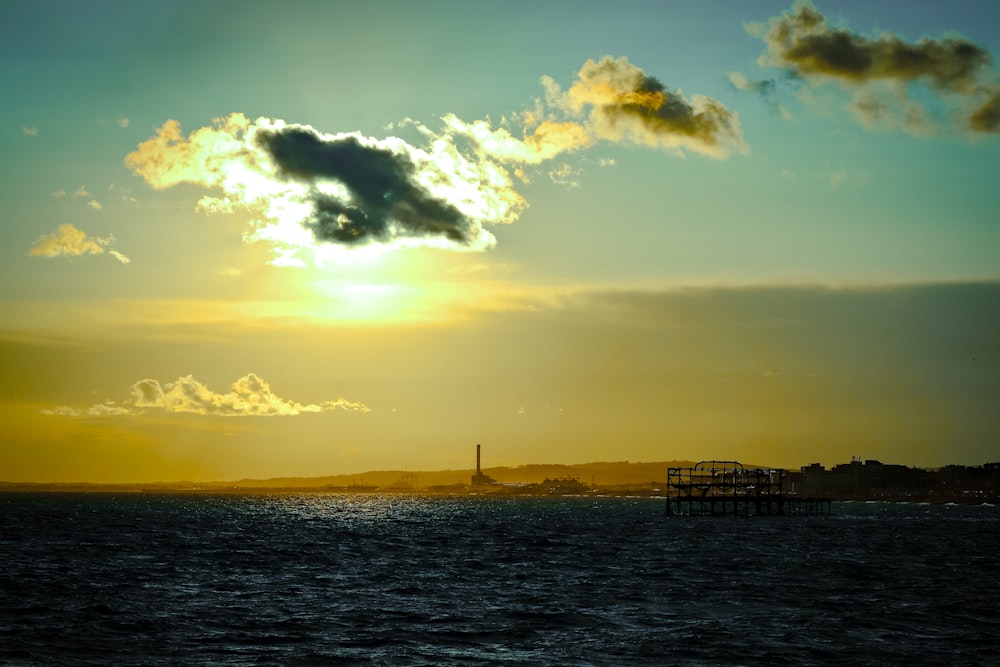 a large body of water with a sky in the background