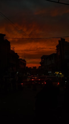 A dramatic black and white shot of an urban street scene at dusk.