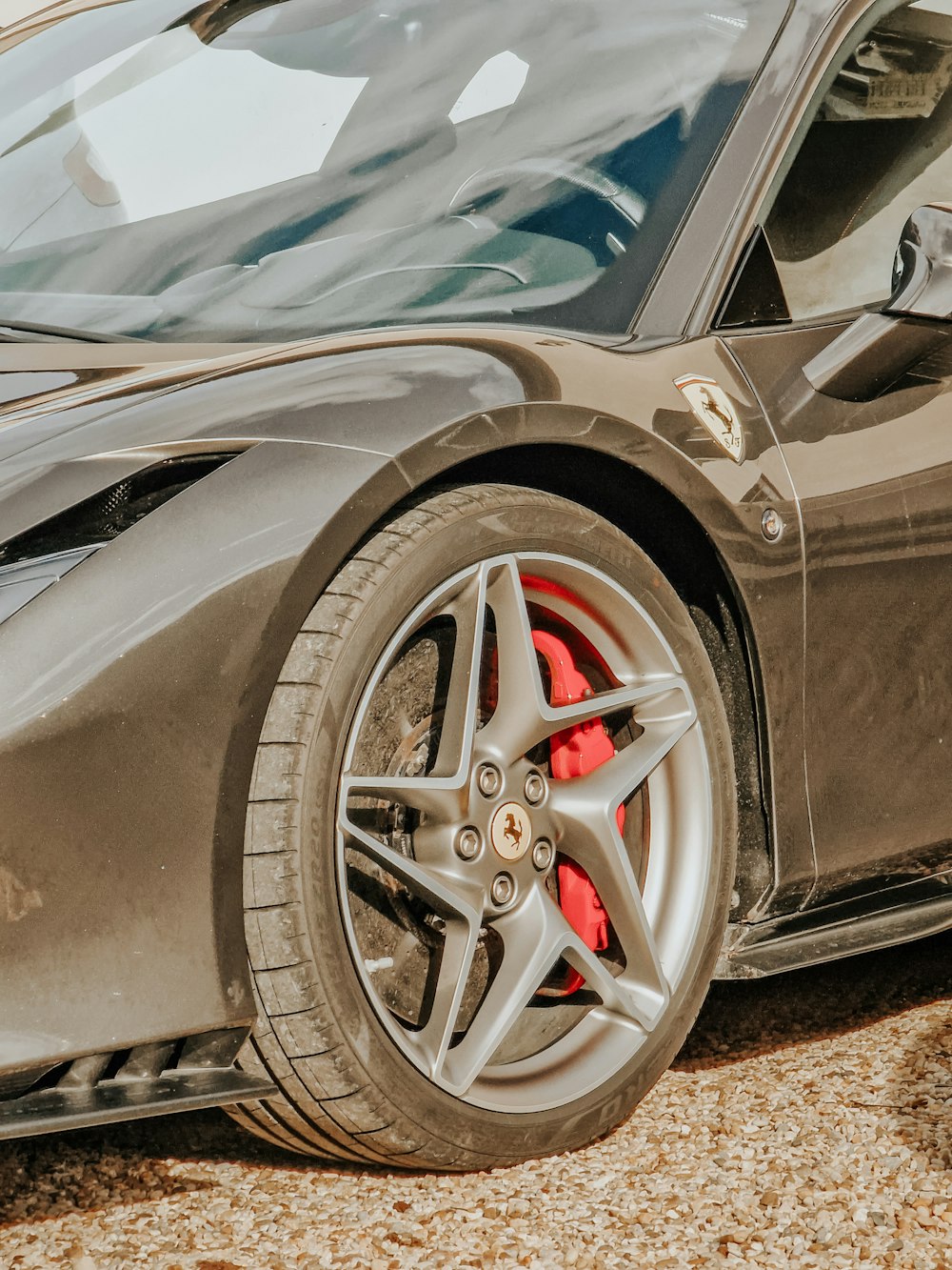 a close up of a sports car parked on the side of the road