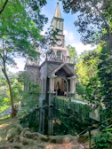 A serene old meeting house surrounded by lush greenery under a soft morning light