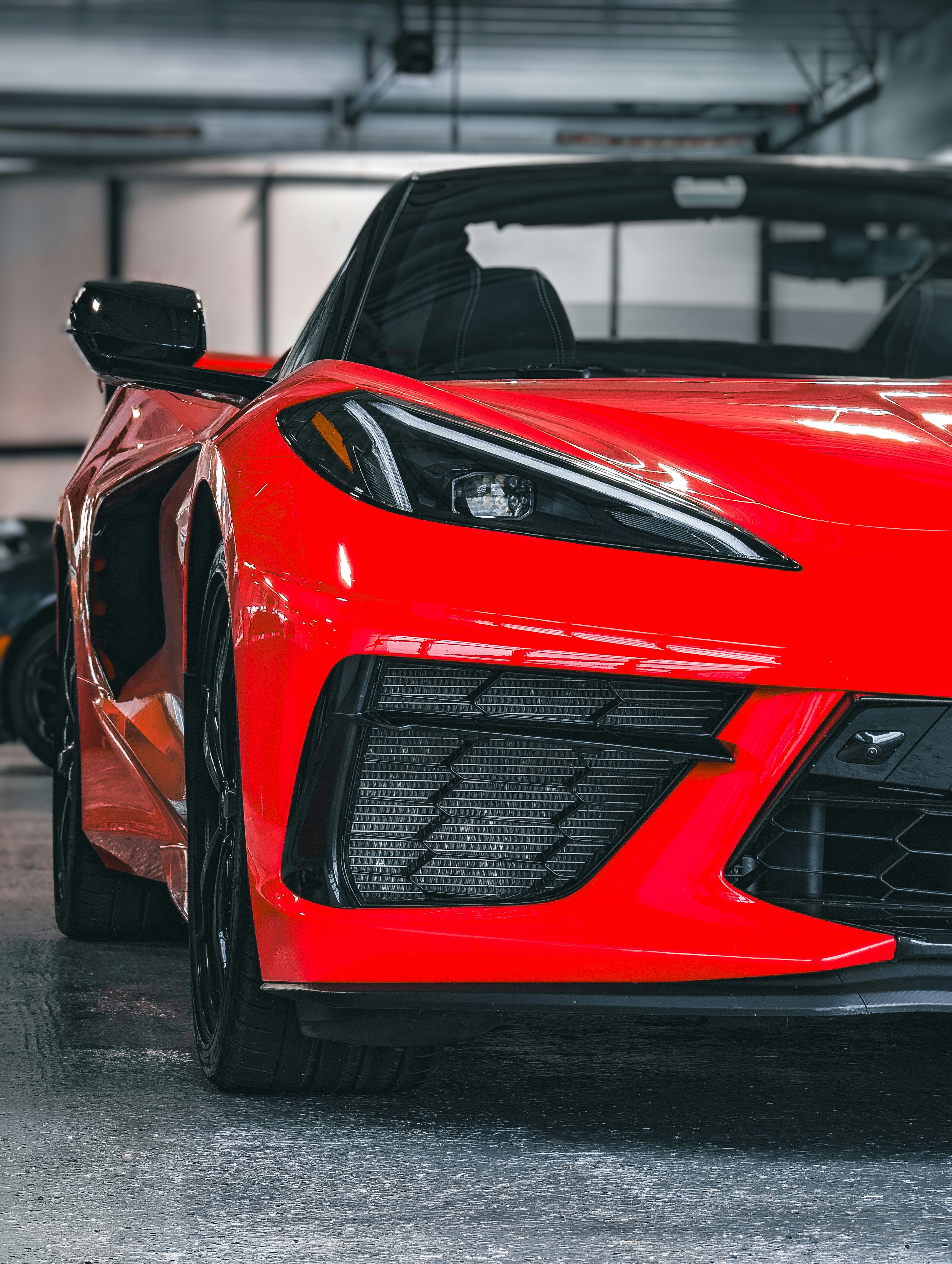 a red sports car parked in a garage