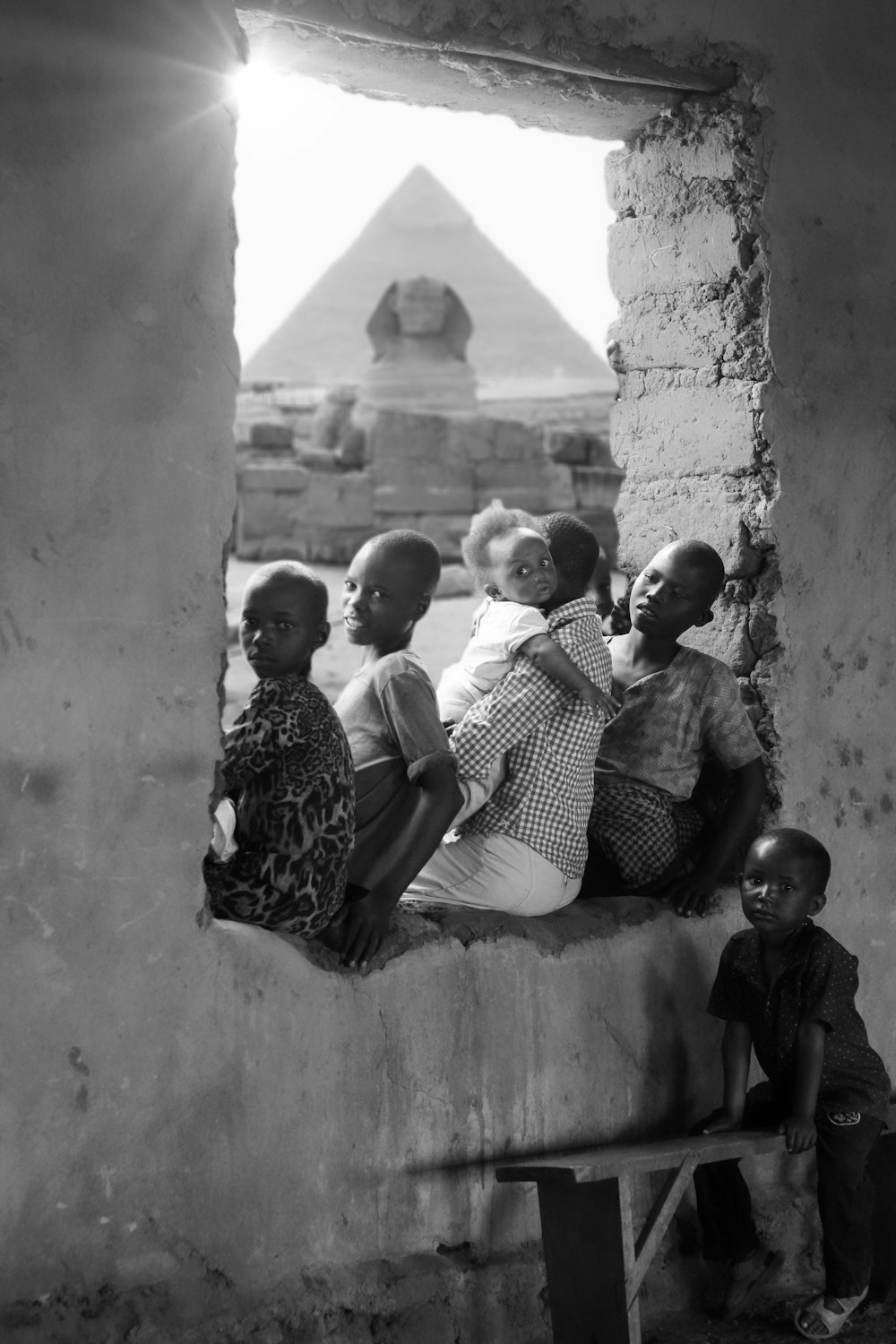 a group of people sitting on a window sill