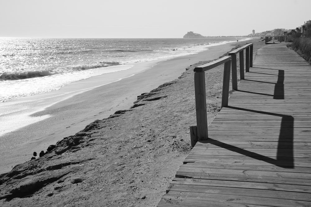 a long wooden boardwalk next to the ocean