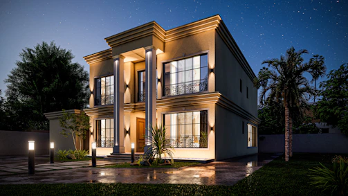 Elegant nighttime exterior of a modern luxury home with warm interior lights glowing through large windows.