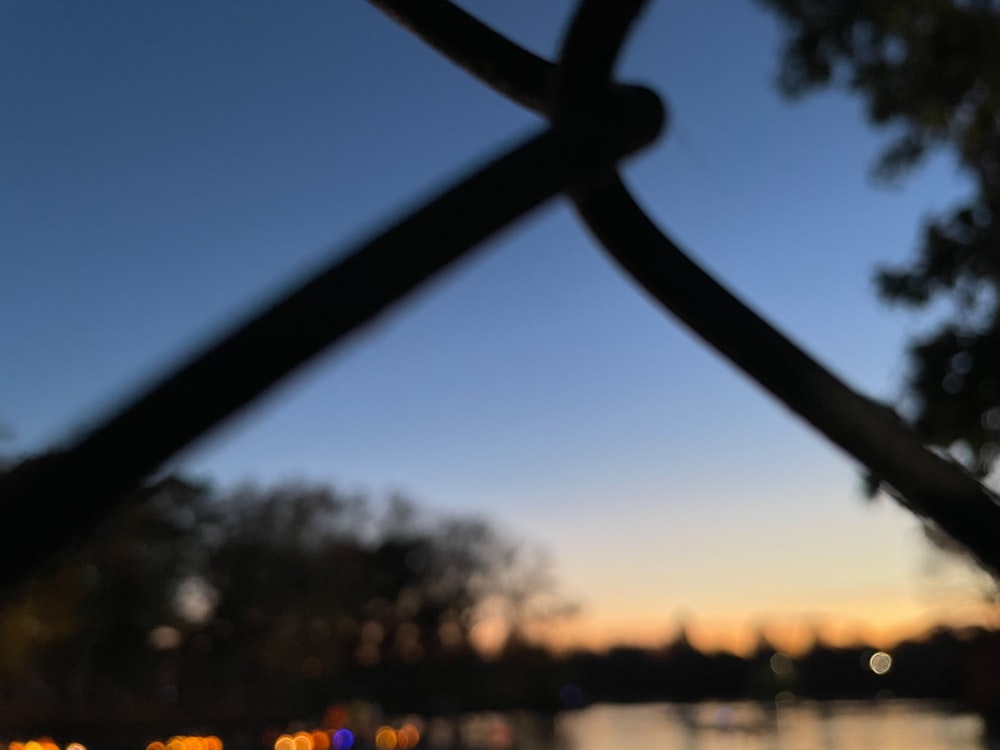 a view of a body of water through a fence