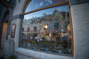 Close-up of a shop window displaying a variety of artisanal products.