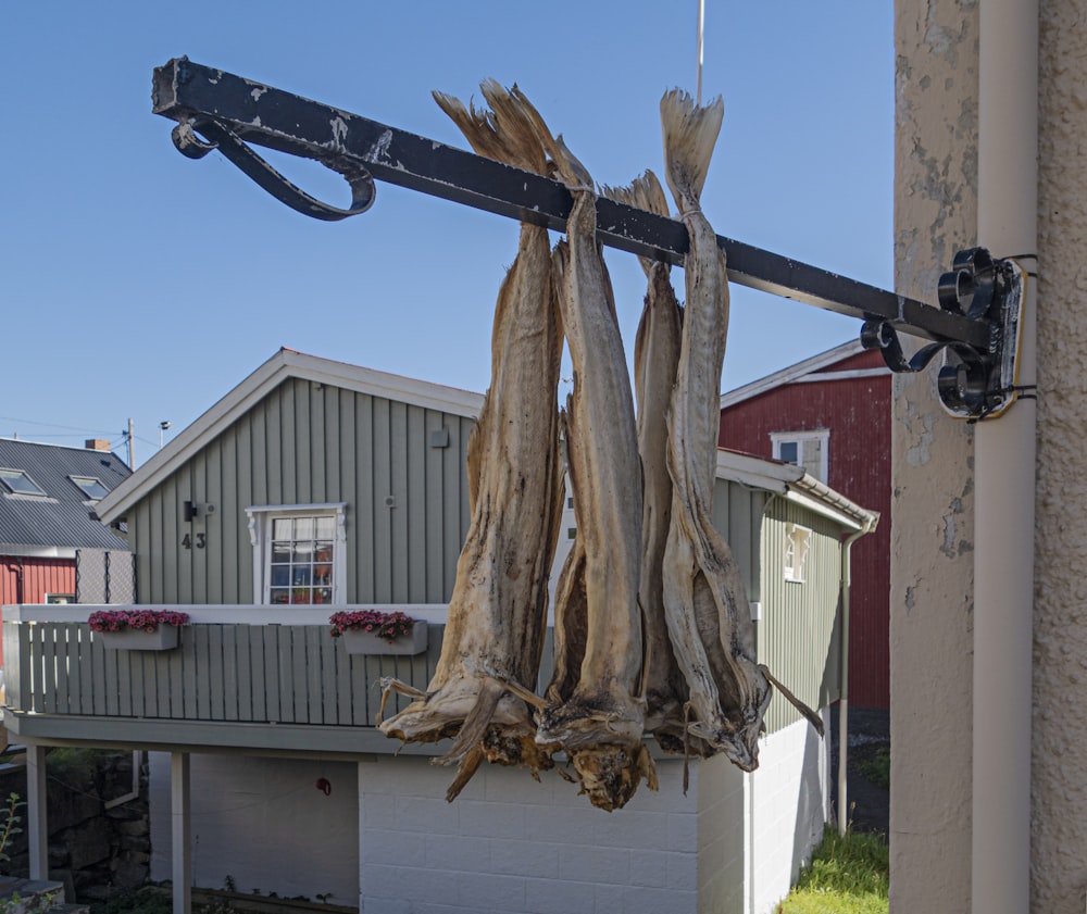 a large piece of wood hanging from a pole