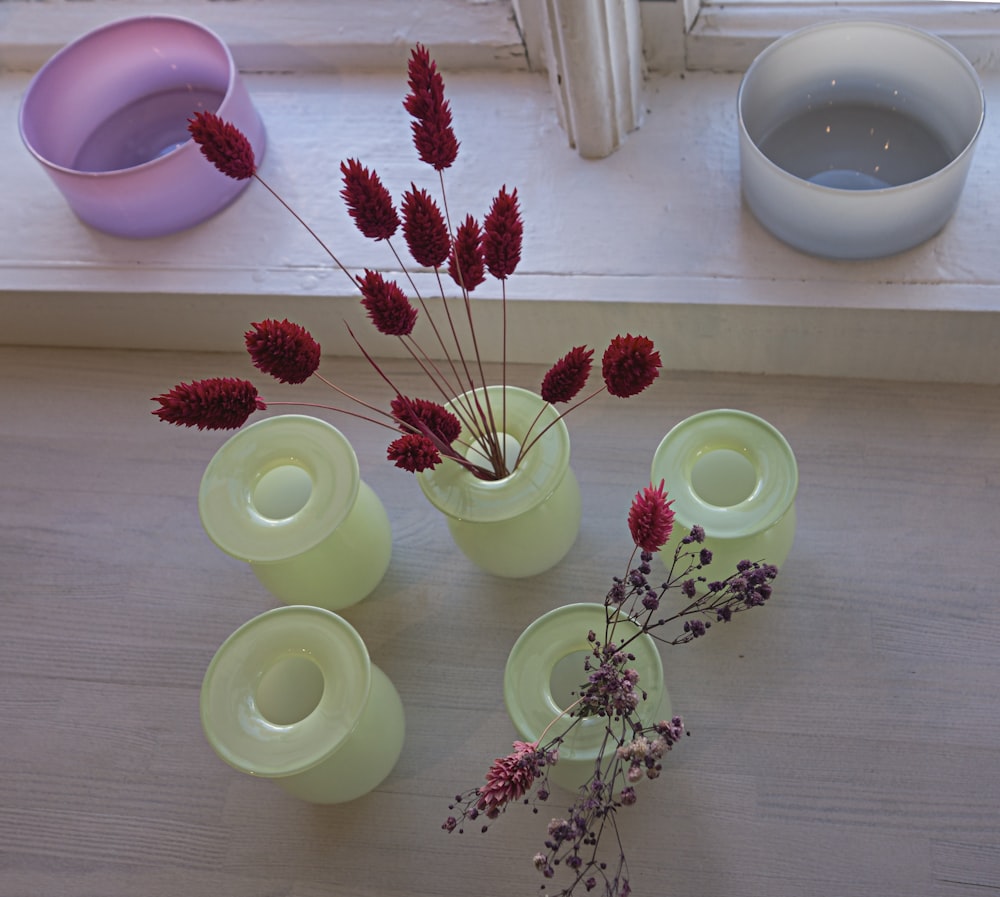 a group of vases sitting on top of a wooden table