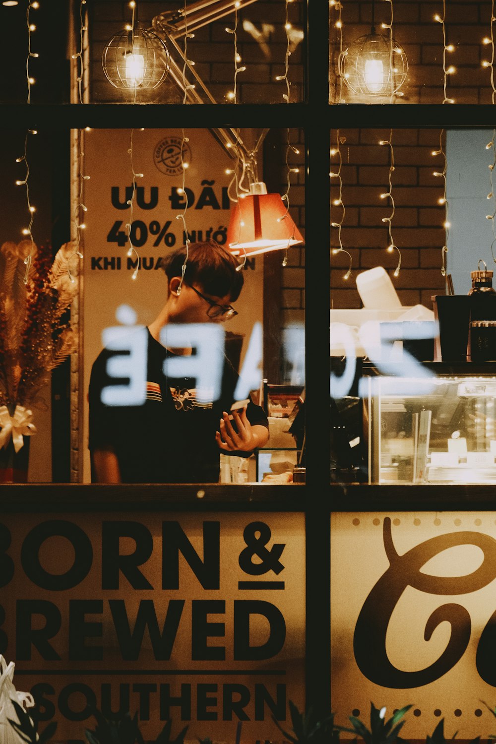 a store front window with a man working in the window