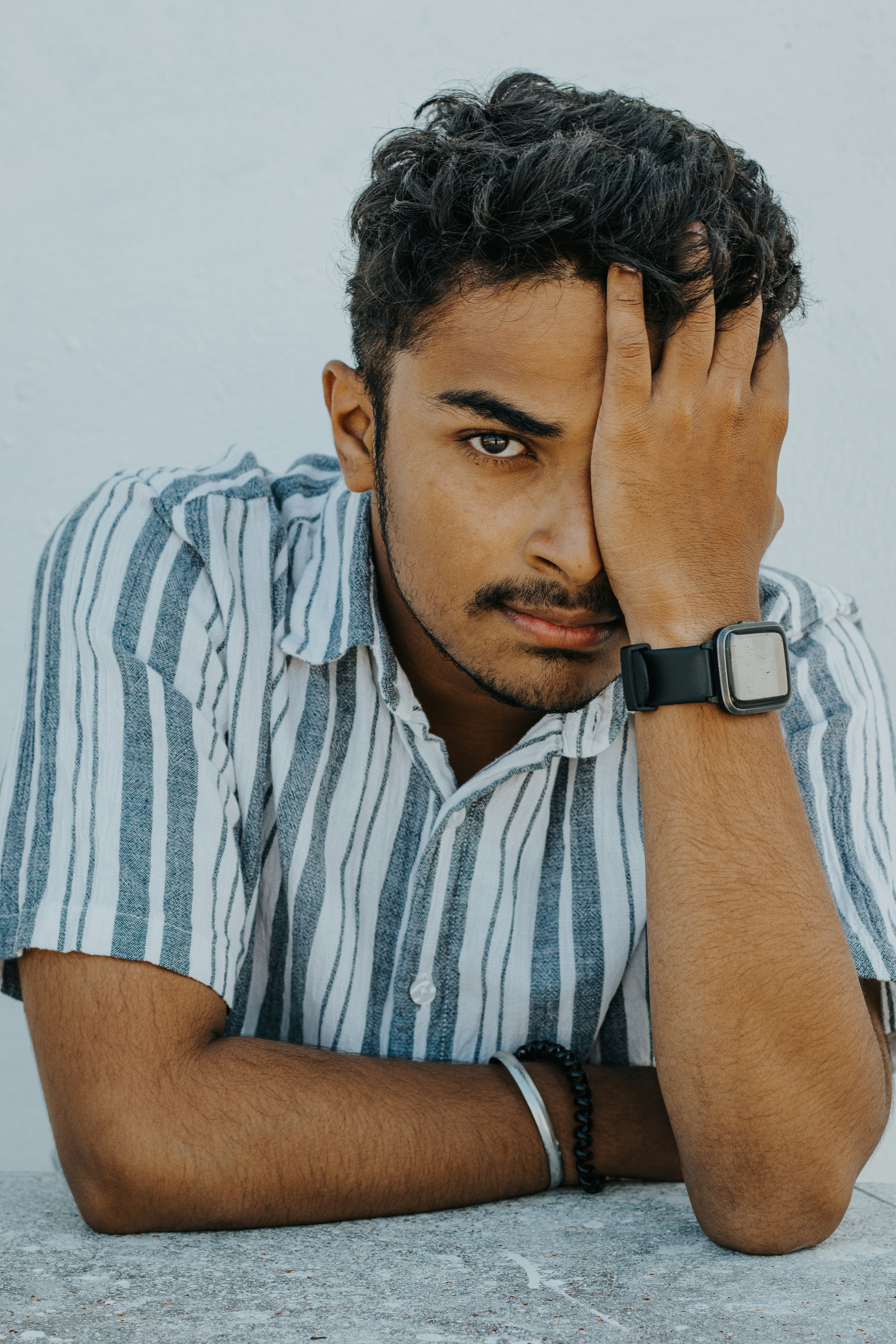 a man with his hand on his face