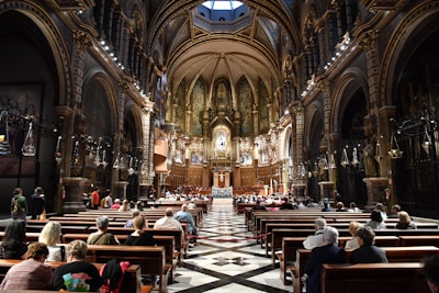 A church interior filled with worshippers during a service.