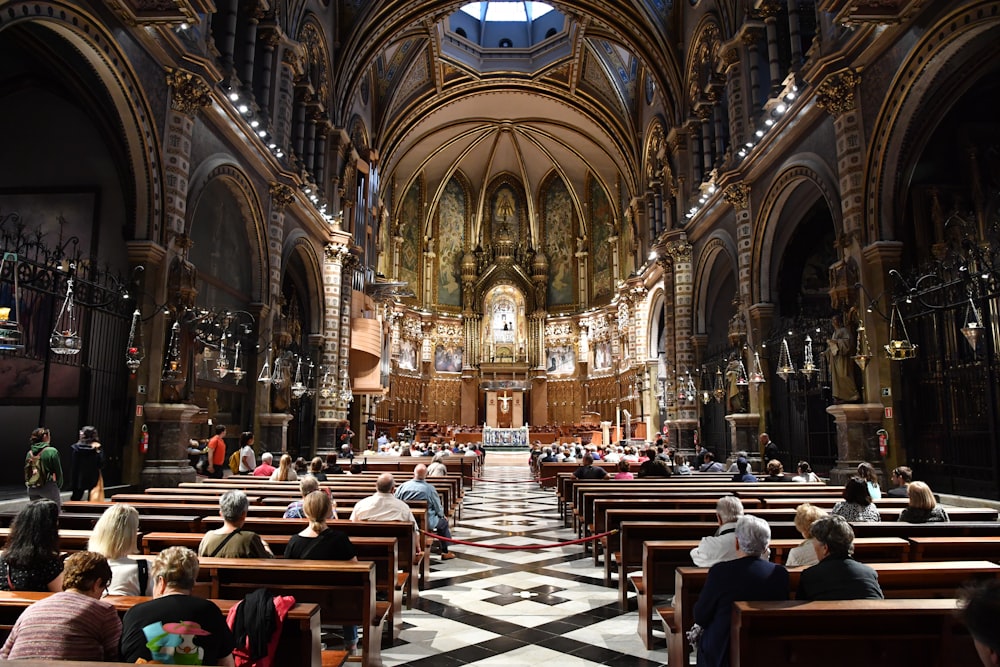 a group of people sitting in pews in a church