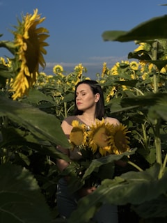 A woman standing strong in a sunlit field, symbolizing hope and new beginnings.