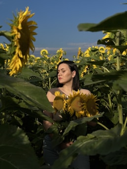 A woman standing strong in a sunlit field, symbolizing hope and new beginnings.