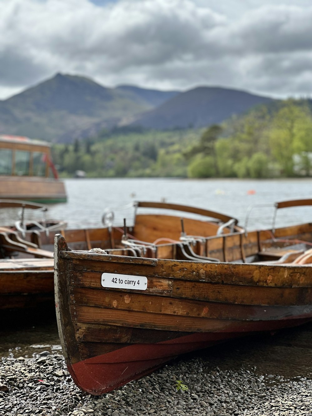 a row of wooden boats sitting on top of a lake