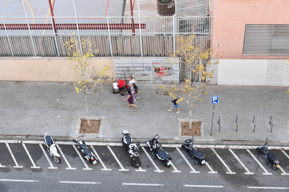 a group of motor scooters parked in a parking lot