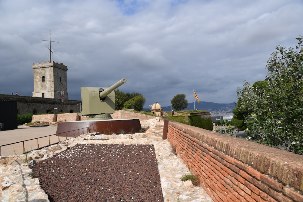 a large tank sitting on top of a brick wall