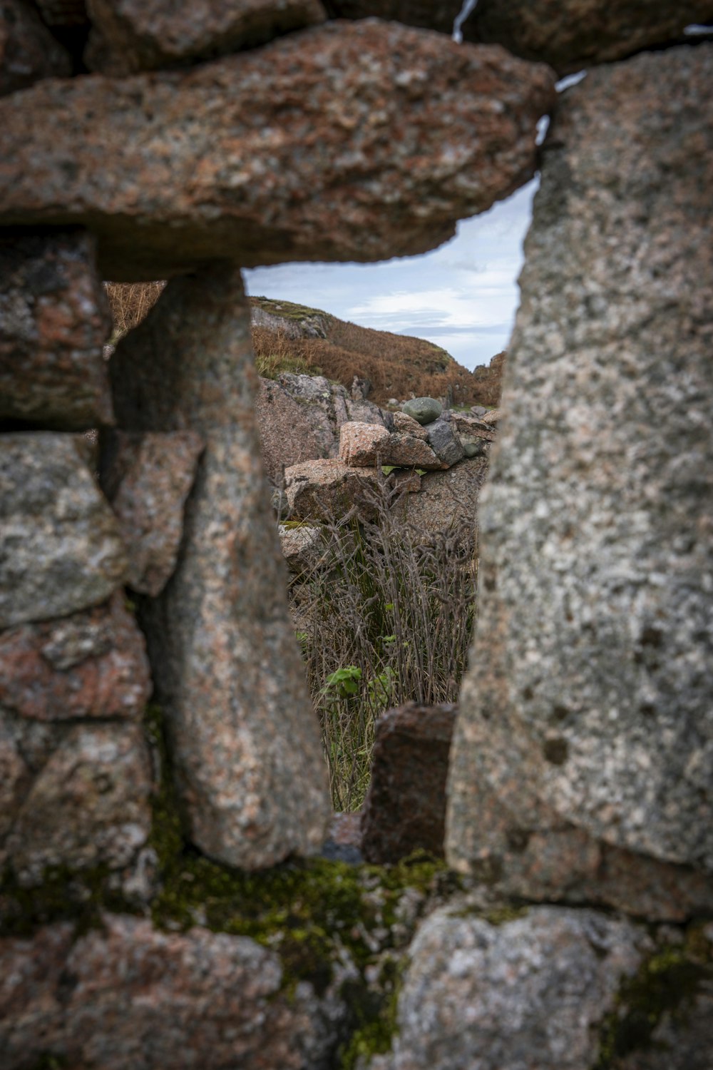 a stone wall with a hole in the middle of it