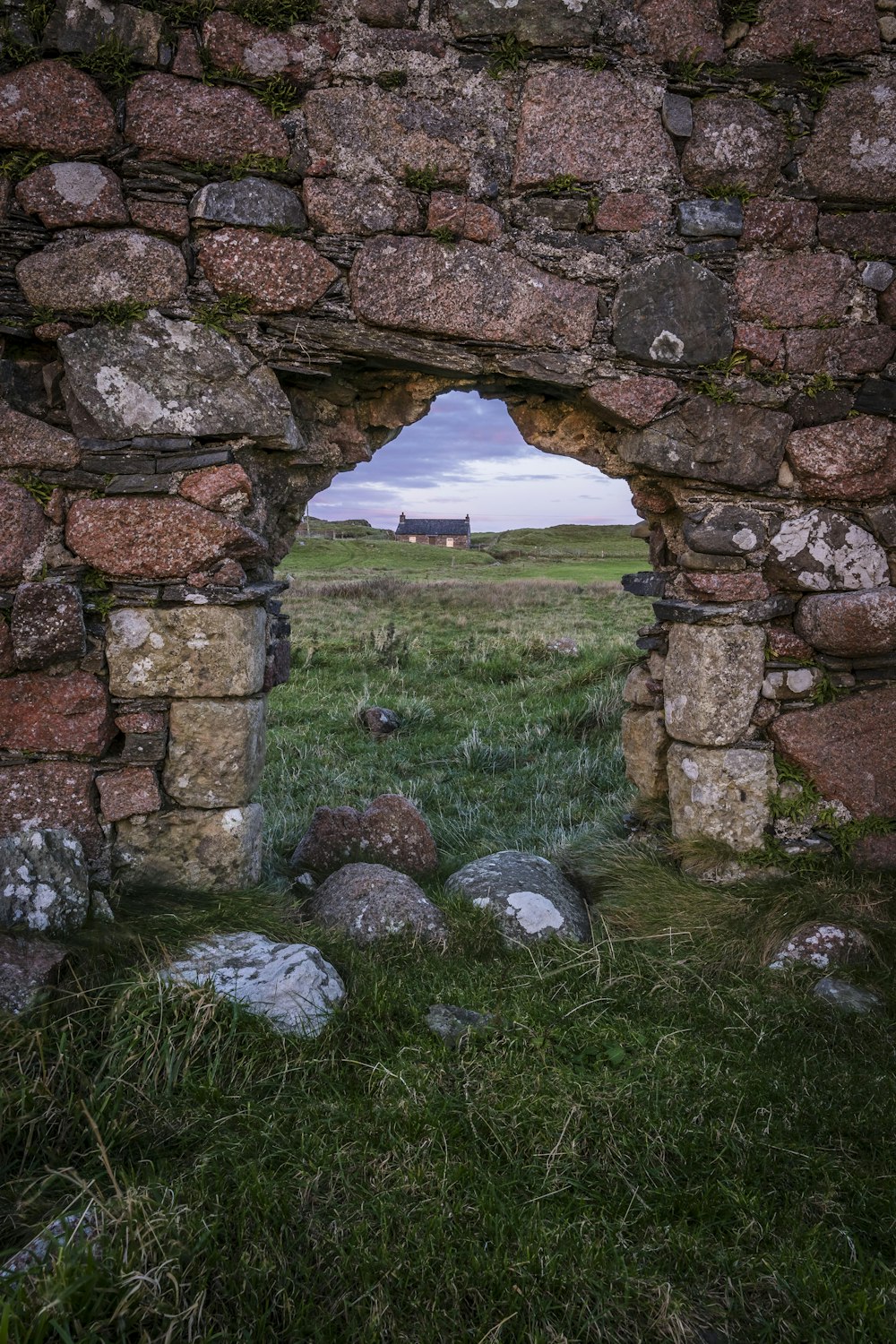 a stone wall with a hole in the middle of it