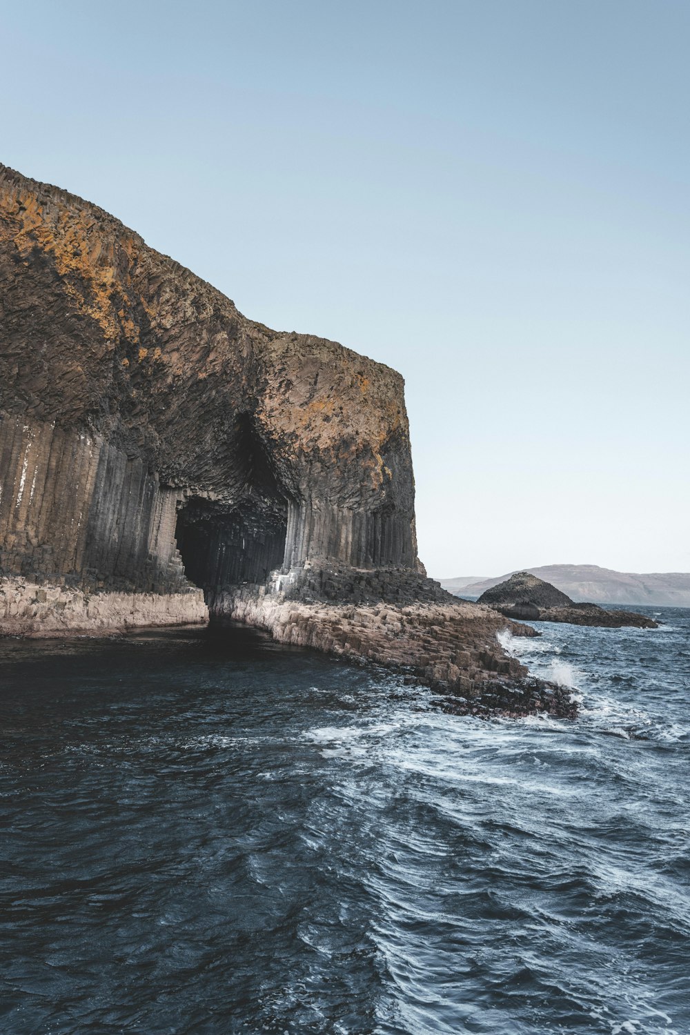 a large rock outcropping into the ocean