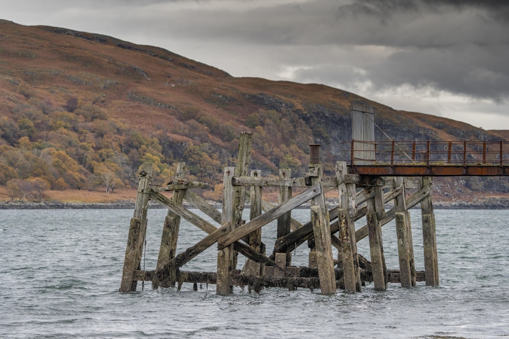 a wooden pier in the middle of a body of water