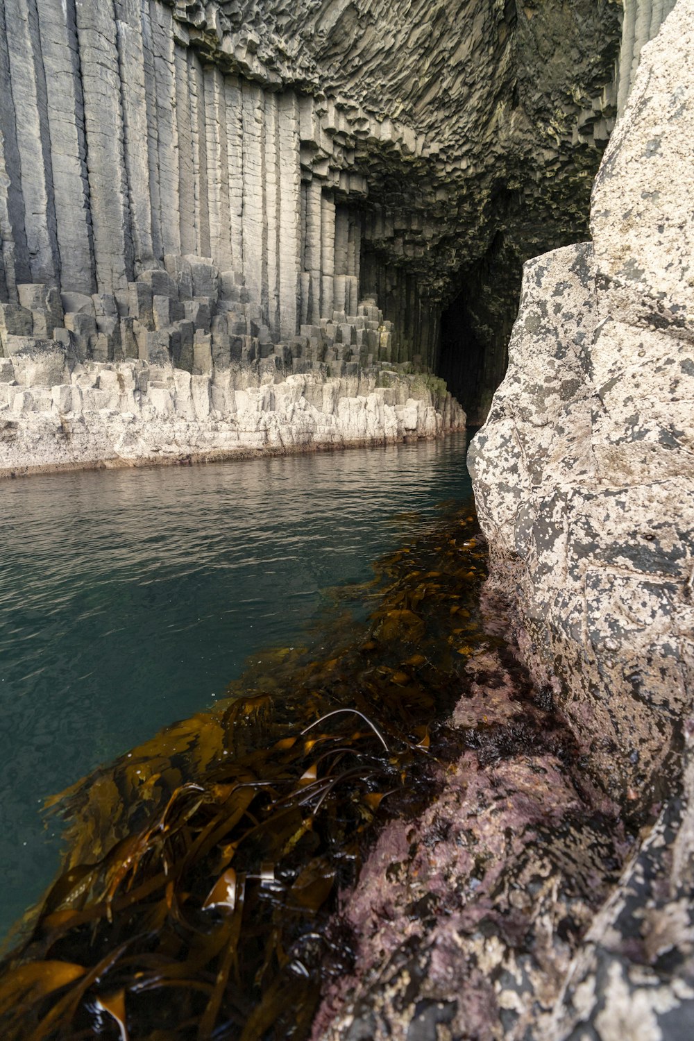 there is a cave with a body of water in it