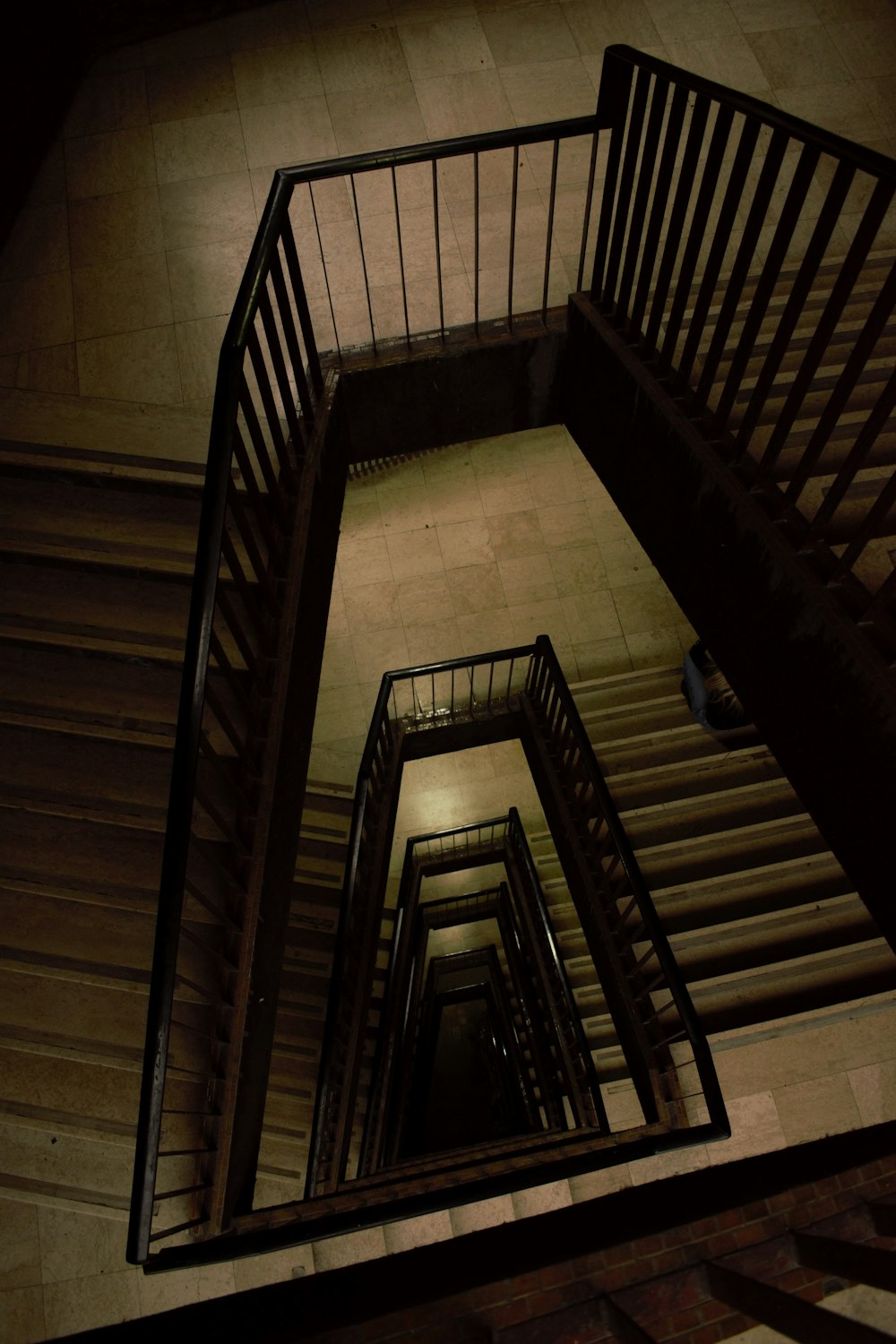 a spiral staircase in a building at night