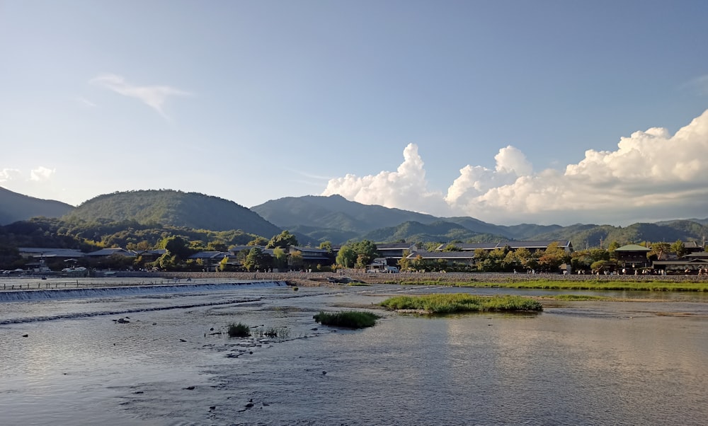 a body of water with mountains in the background