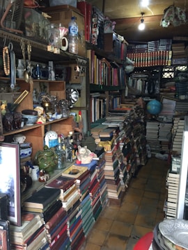 Cluttered living room with mismatched furniture and poor lighting.