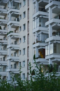 Modern residential building exterior with balconies and greenery