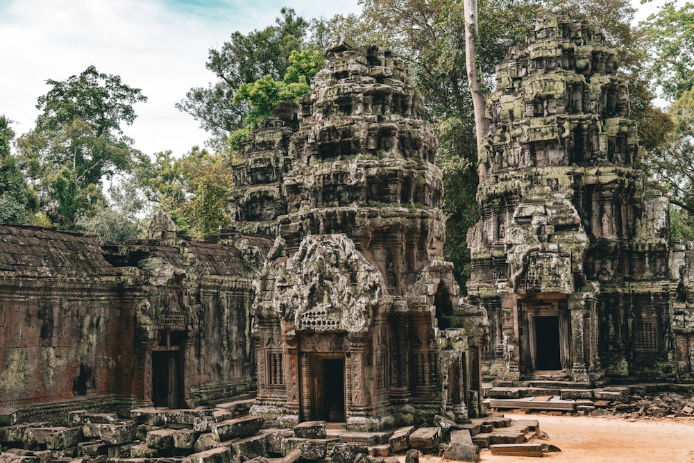 a group of stone buildings with trees in the background