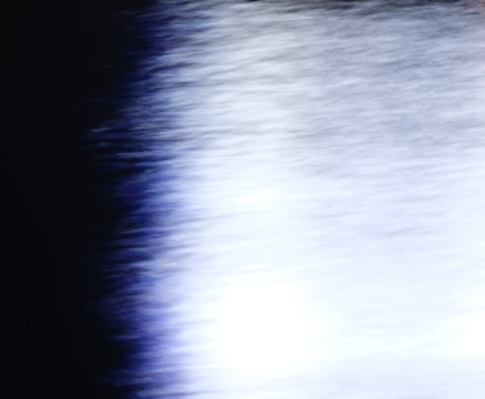 A blurred, dark gradient with subtle light streaks evoking a fading echo.