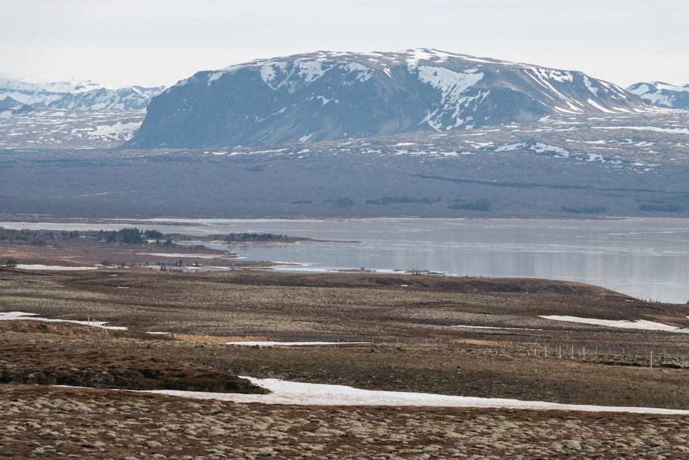 a mountain with a body of water in the foreground