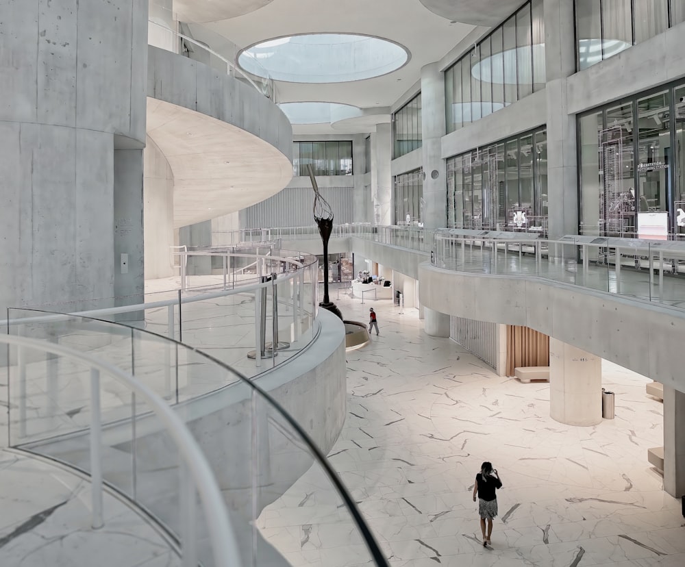 a woman is walking down the stairs of a building