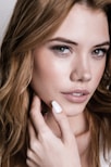 a woman with long hair and a ring on her finger