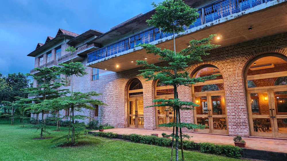 a building with a lot of windows and trees in front of it