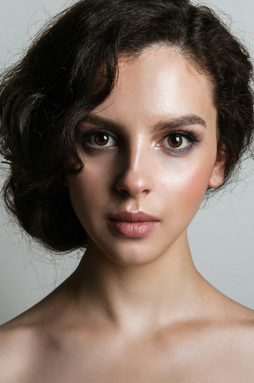 a woman with makeup on her face posing for a picture