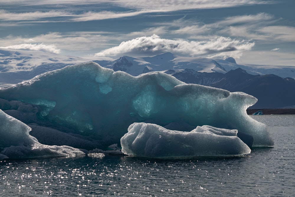 a large iceberg floating on top of a body of water