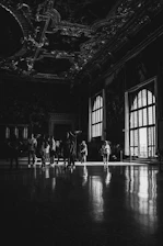 Guided tour group admiring the intricate woodwork and period furnishings of the mansion.