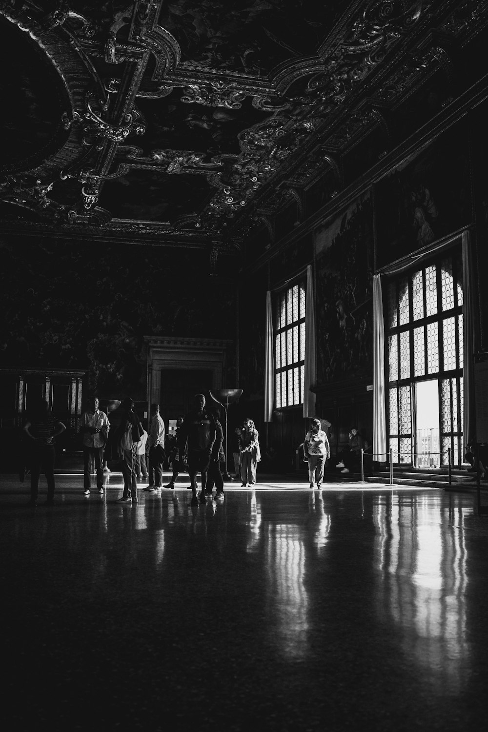 a black and white photo of people in a room