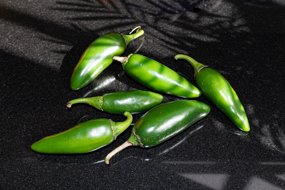 a group of green peppers sitting on top of a counter