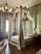 Elegant vintage room with traditional Indian decor and a plush four-poster bed.