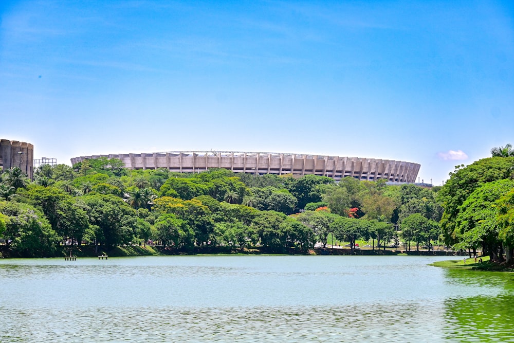 a body of water with a stadium in the background