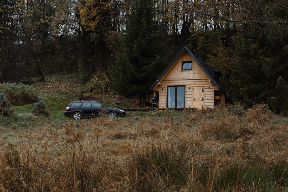 a car parked in front of a wooden cabin